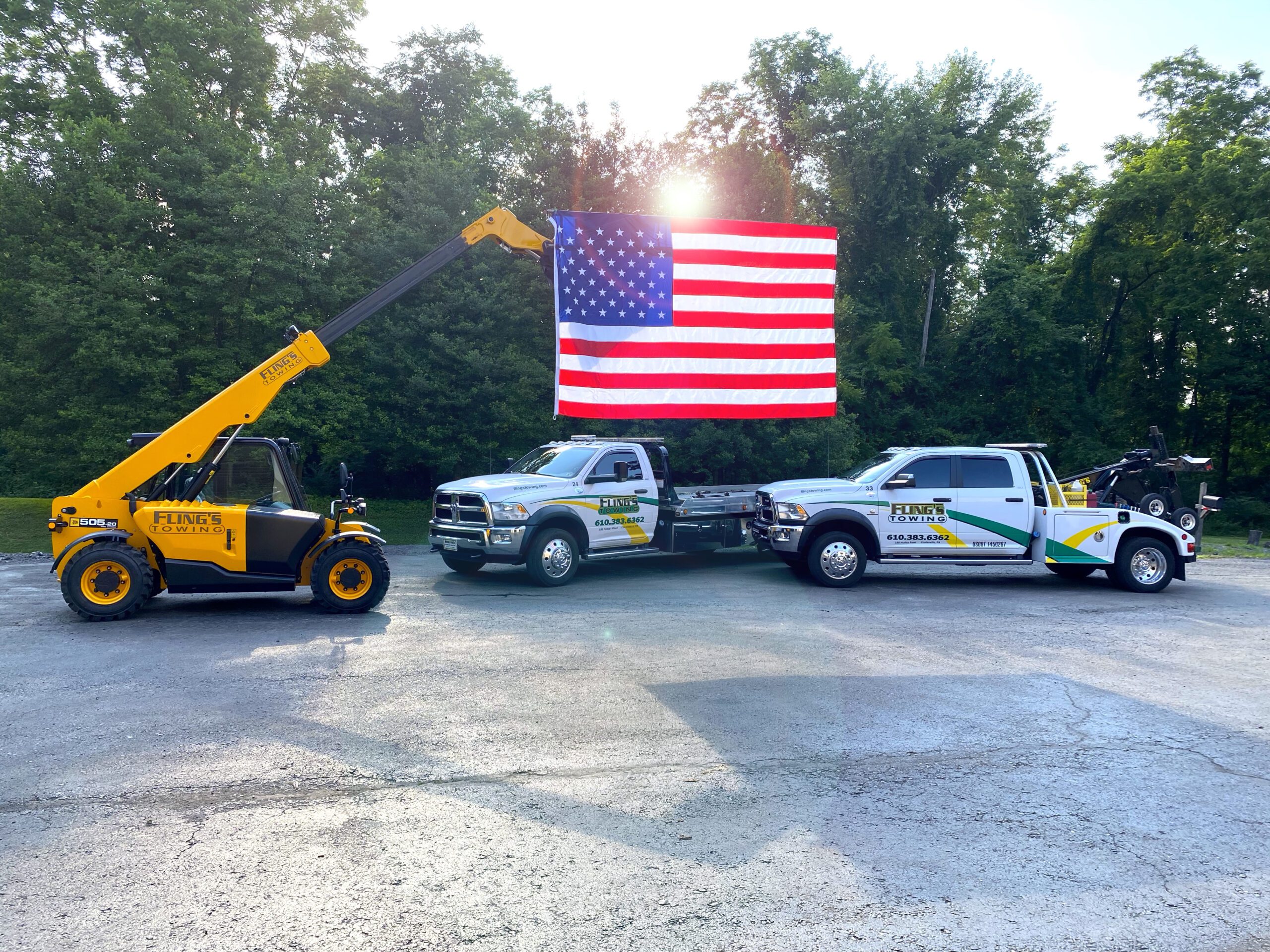 Forklift hanging an American flag with part of the fleet in Coatesville PA