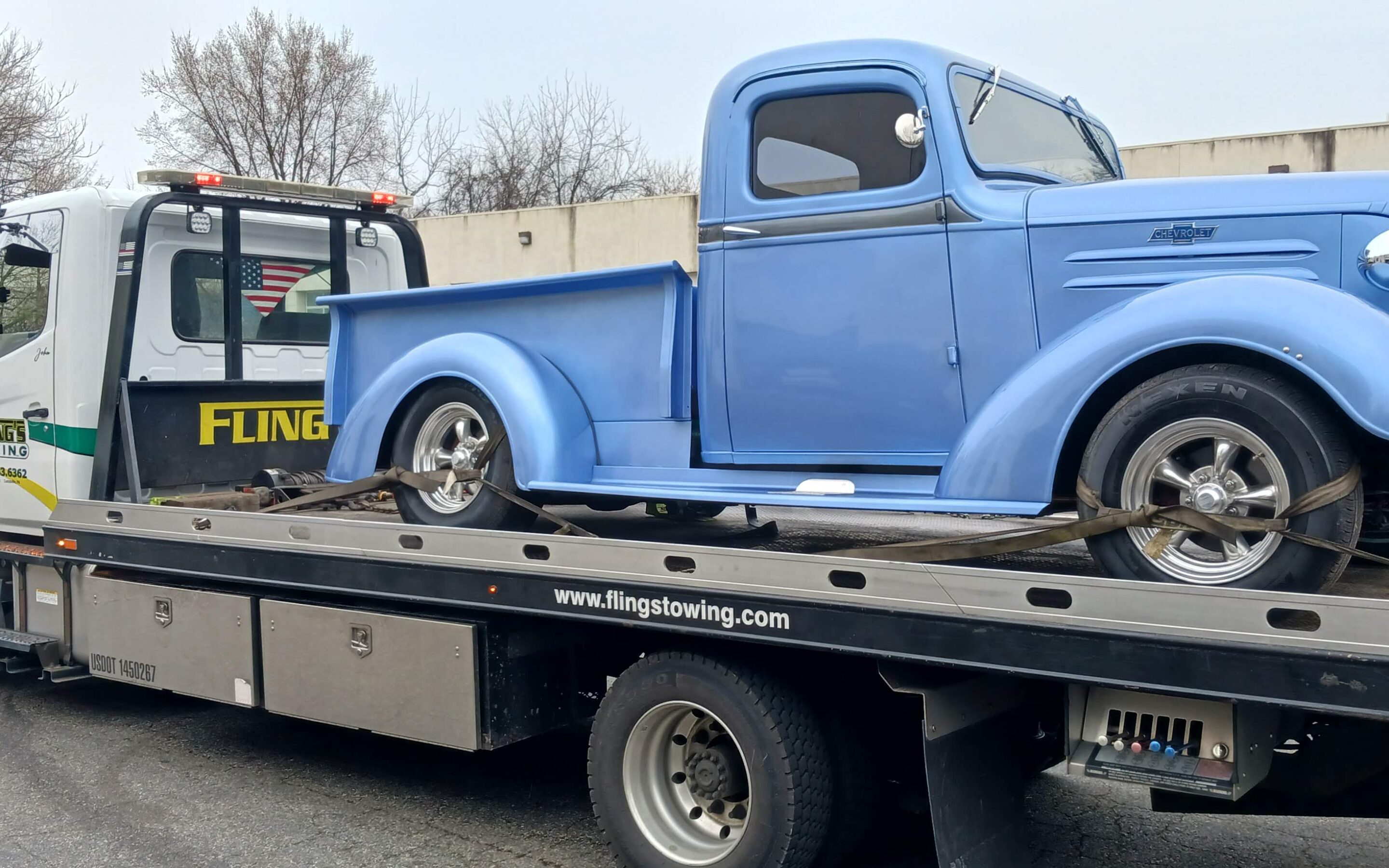 Classic antique truck being towed on a flatbed truck in Downington PA