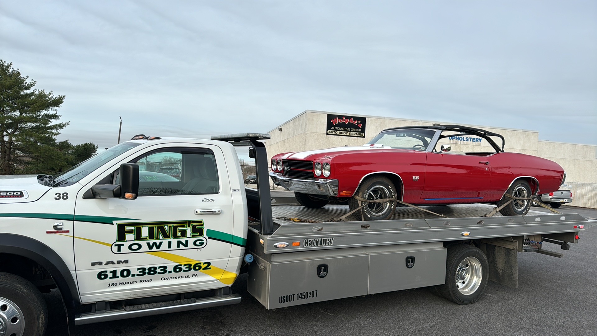 Classic antique convertible being towed on a flatbed truck in Exton PA