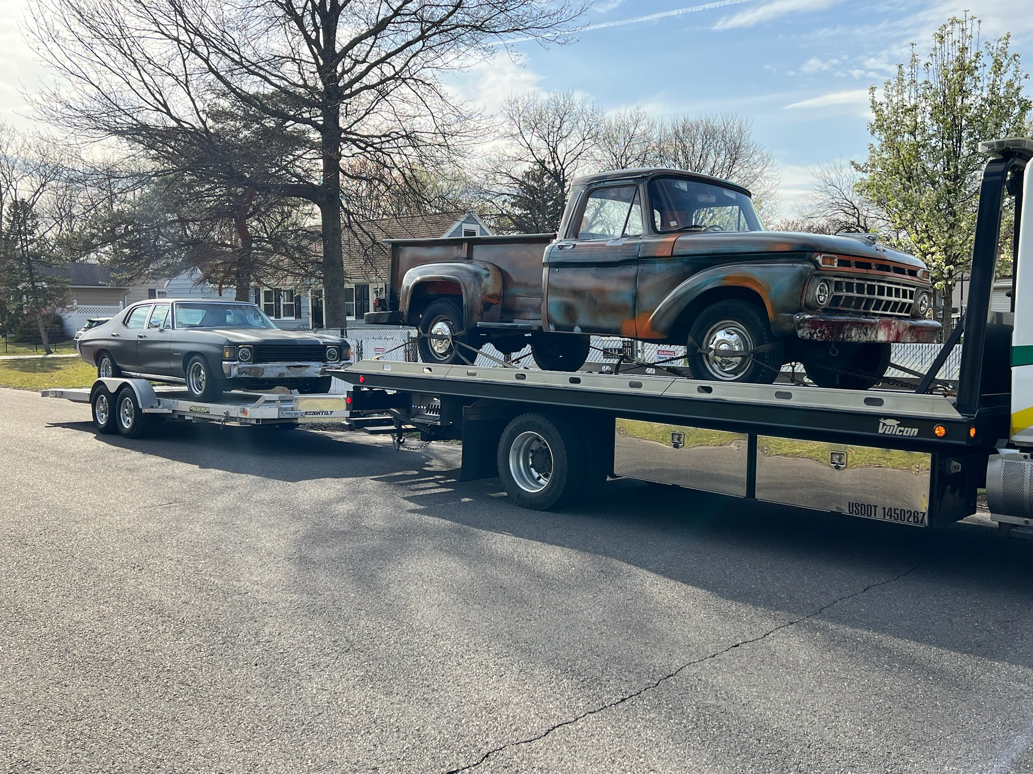 Classic car and antique truck being towed on a flatbed truck and trailer attachment in Downingtown PA