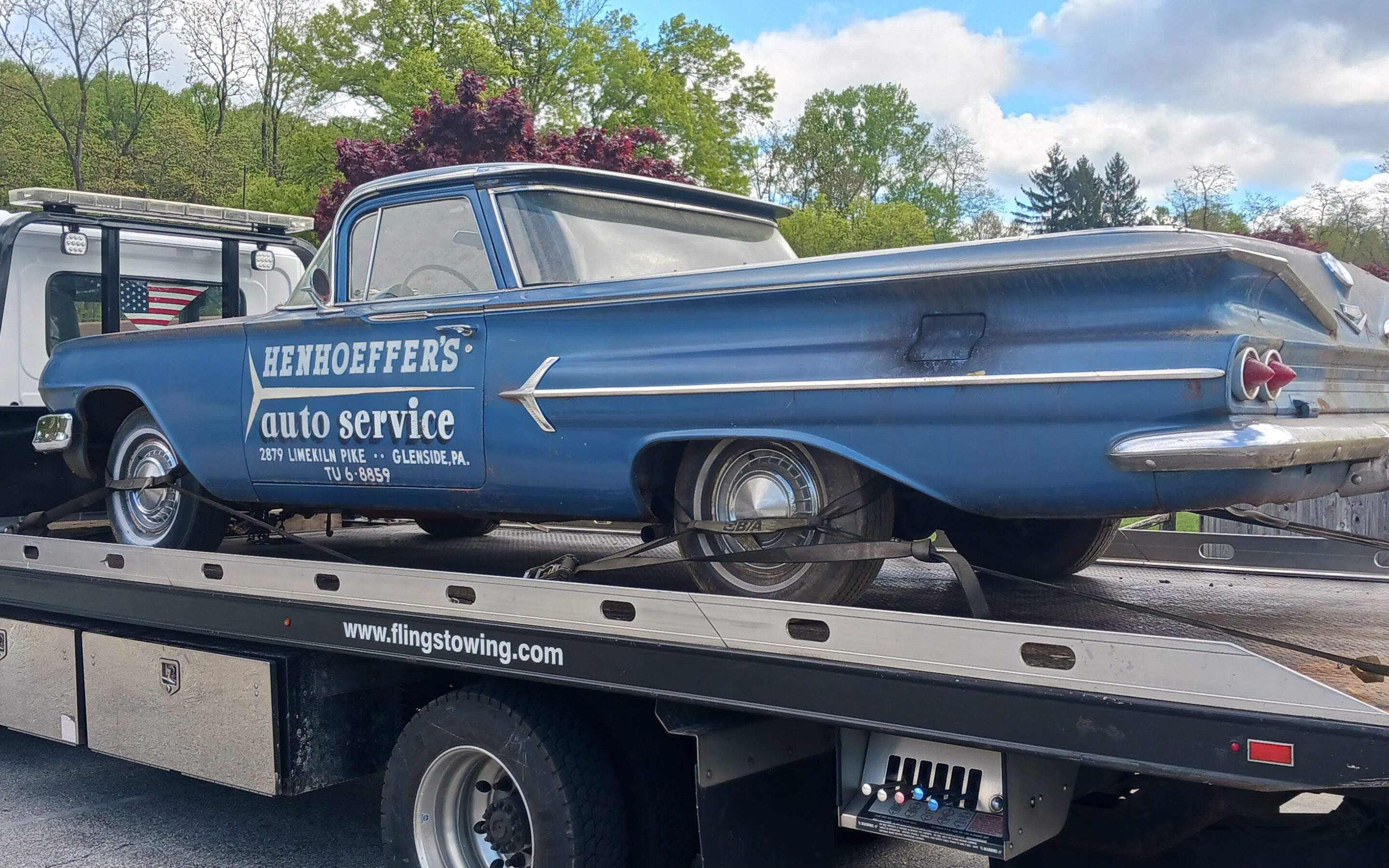 Classic antique car being towed on a flatbed truck in Chester County PA