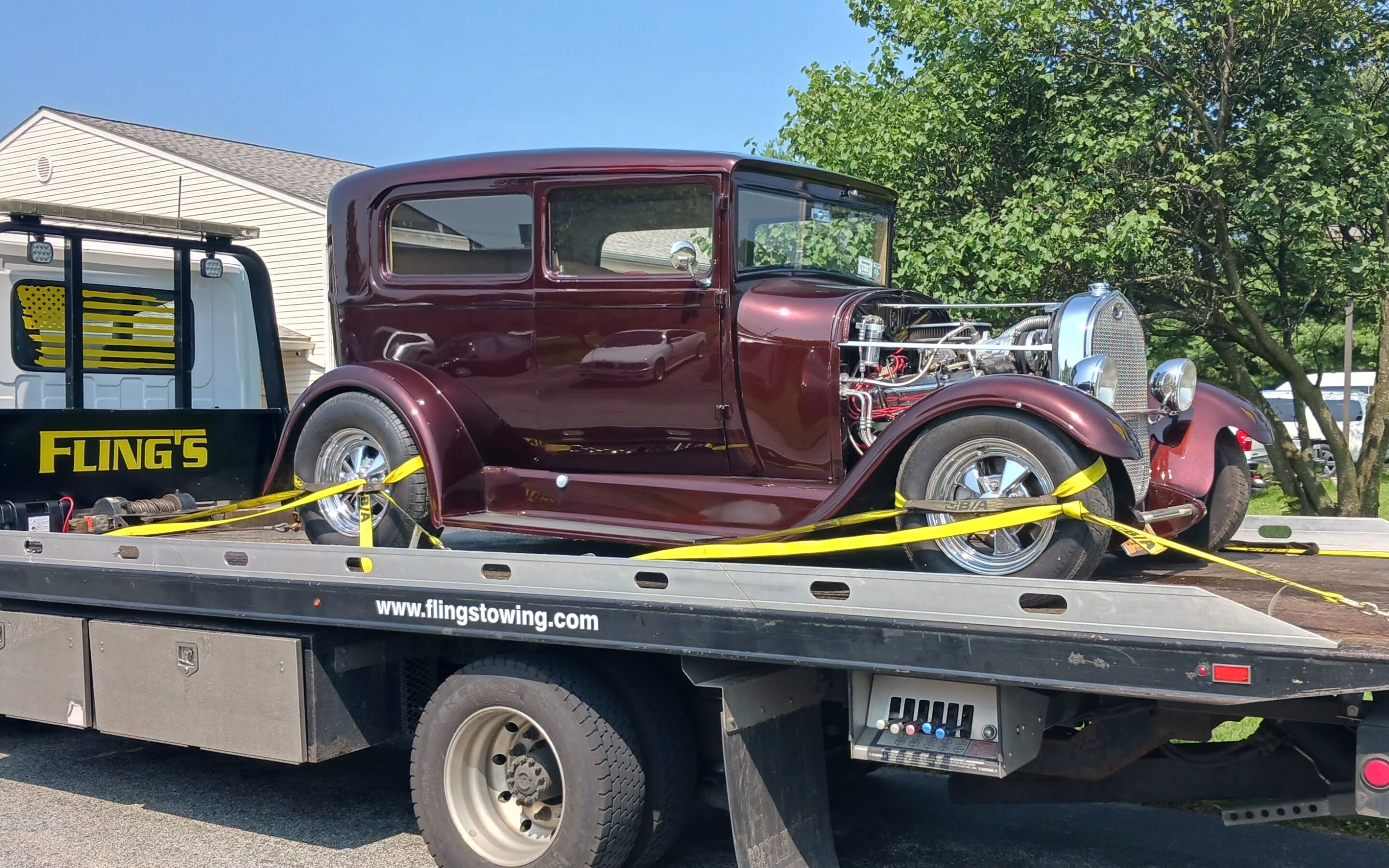 Classic antique car being towed on a flatbed truck in Coatesville PA