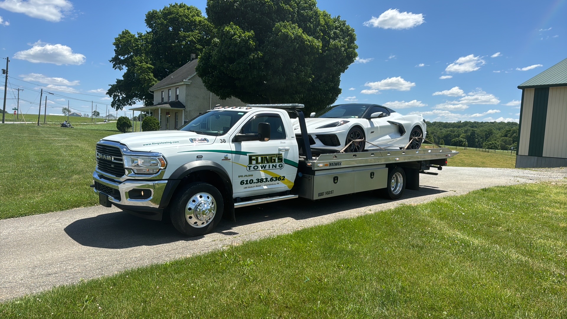 Lowered corvette car being loaded on to a flatbed truck in Downington PA