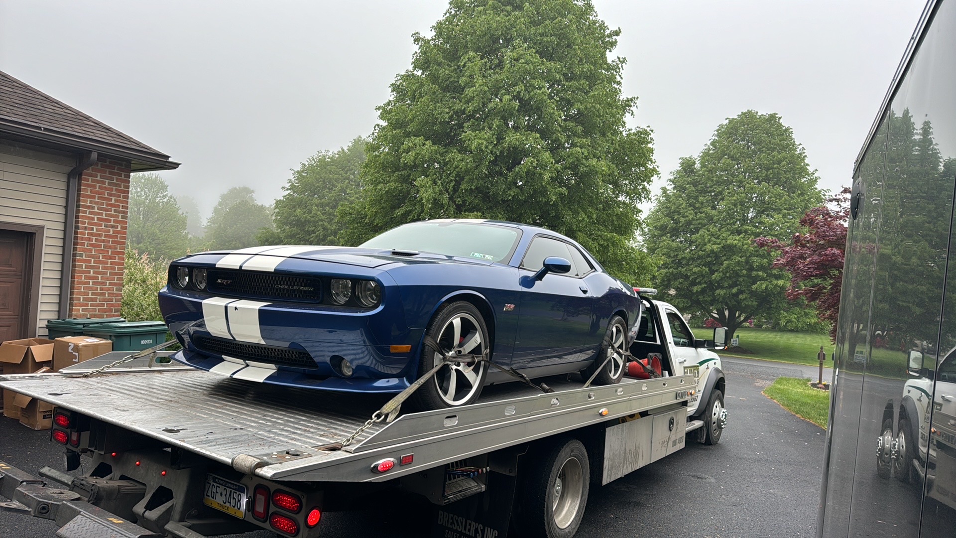 Lowered Dodge Charger being towed on a flatbed truck in Thorndale PA