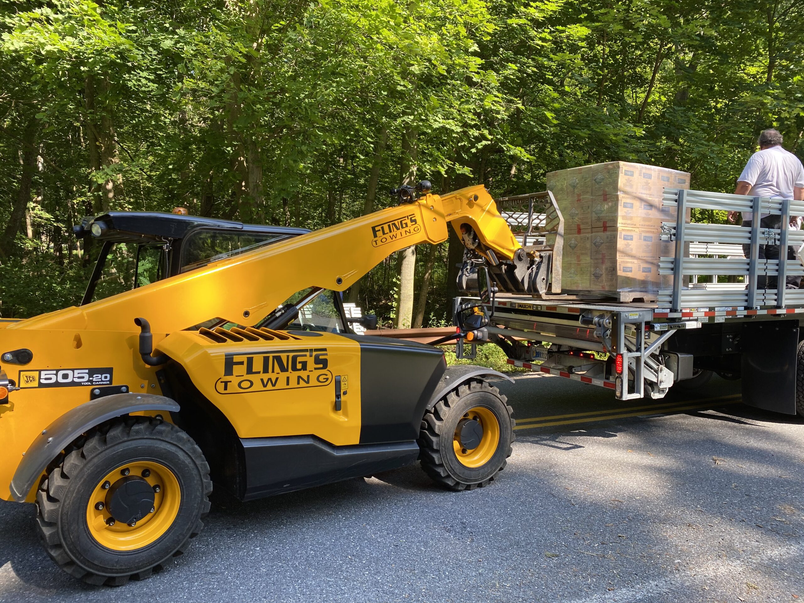 Forklift machine loading pallets onto a flatbed truck in Parkesburg PA